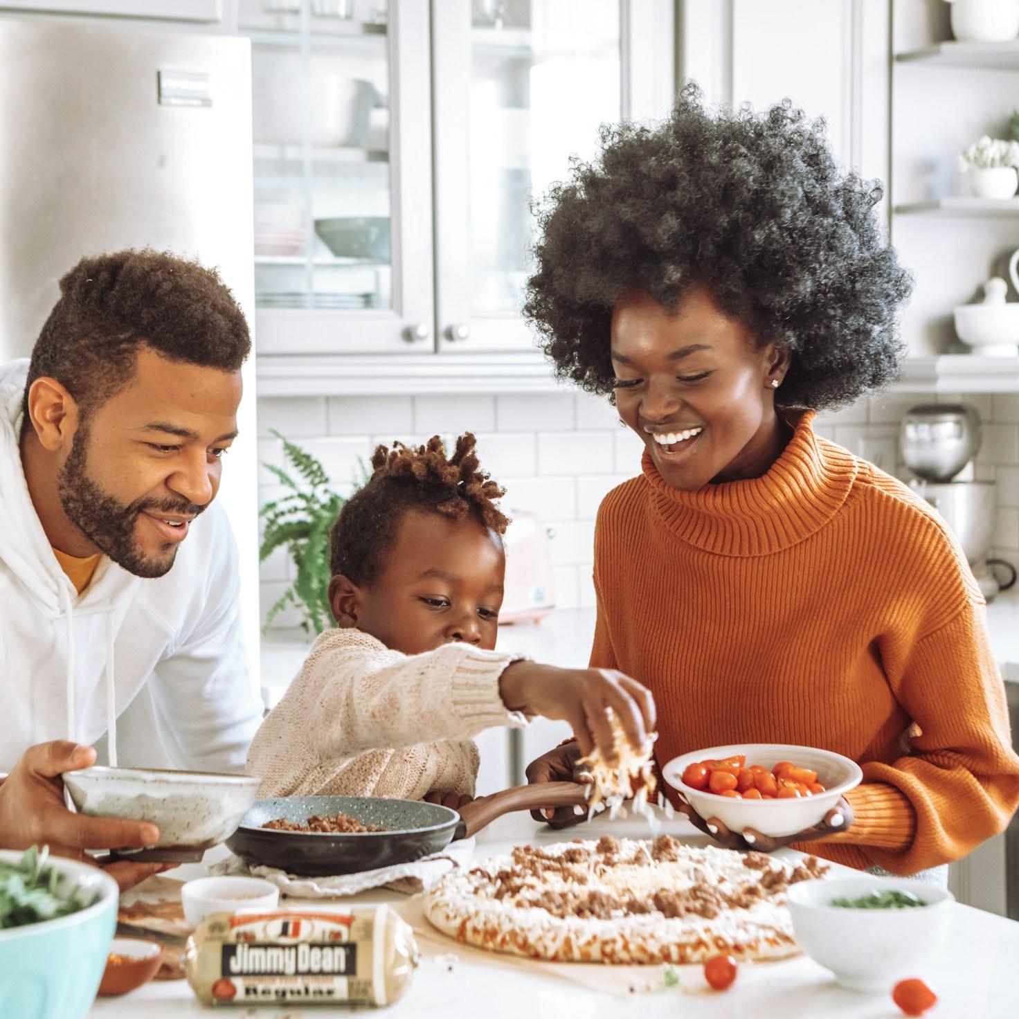 Community members collaborating in a contemporary kitchen, exchanging recipes and techniques